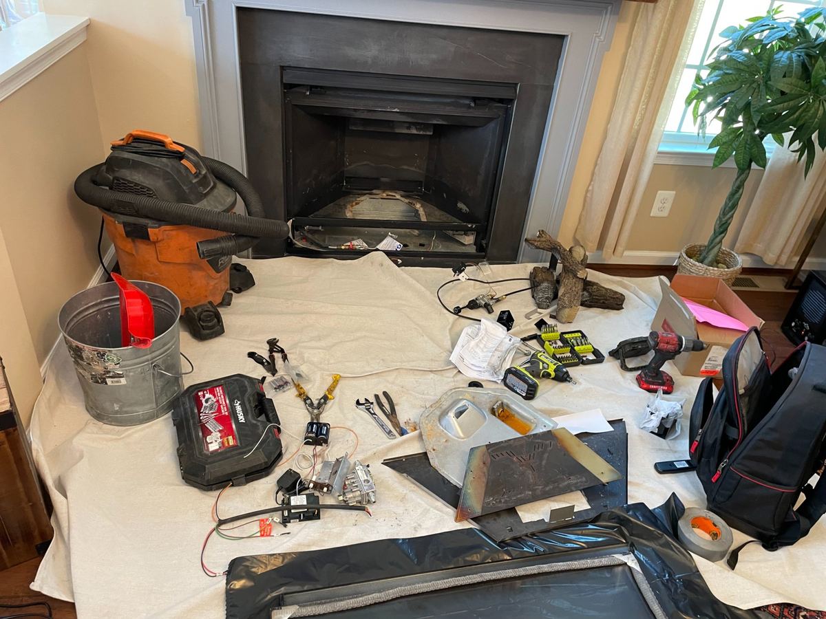 Chimney sweeping service setup with drop cloths in Greater Boston