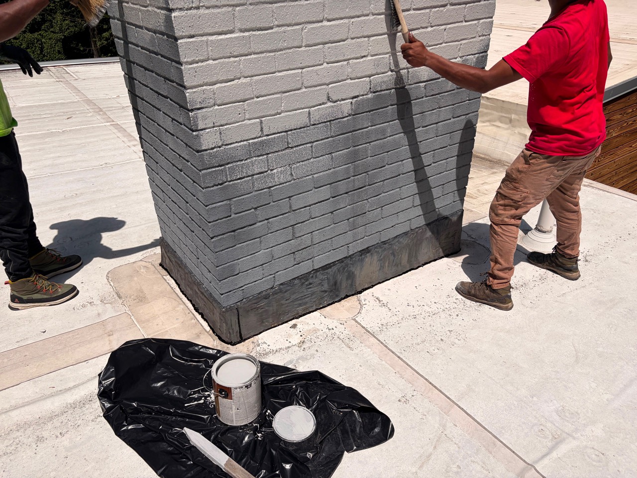 Team completing exterior chimney painting in Wayland MA