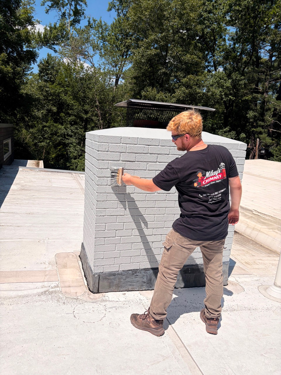 Mikey's Chimney technician applying the selected paint color in Wayland MA