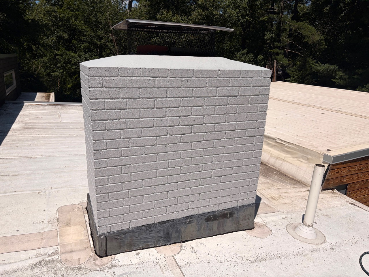 Finished chimney after repointing and painting in Wayland MA
