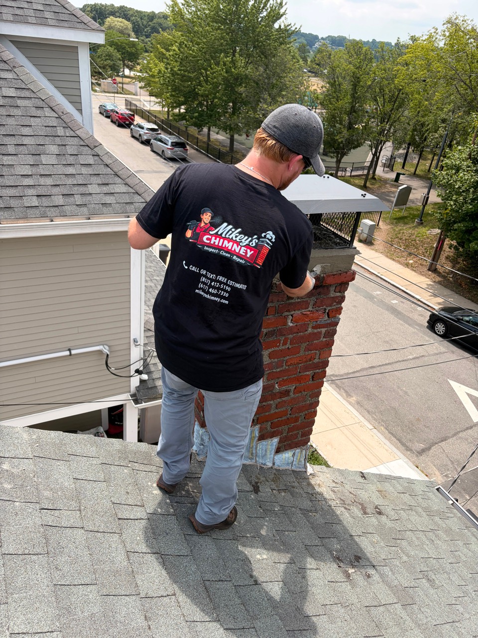 Mikey's Chimney technician completing a chimney cap installation in Boston MA