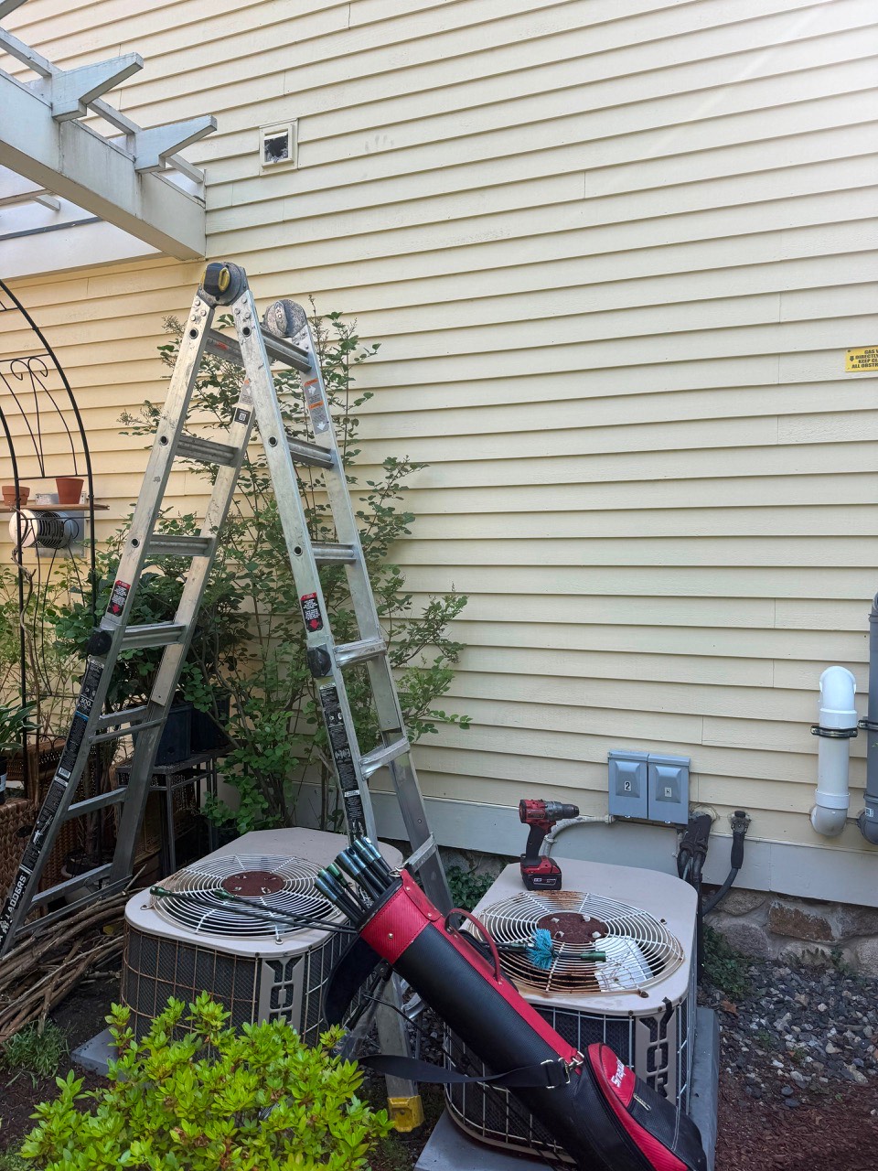 Exterior dryer vent cleaning by ladder in Lexington MA